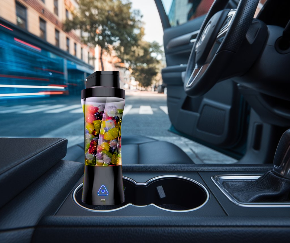Black portable blender in a car cup holder, ideal for blending smoothies on the go.