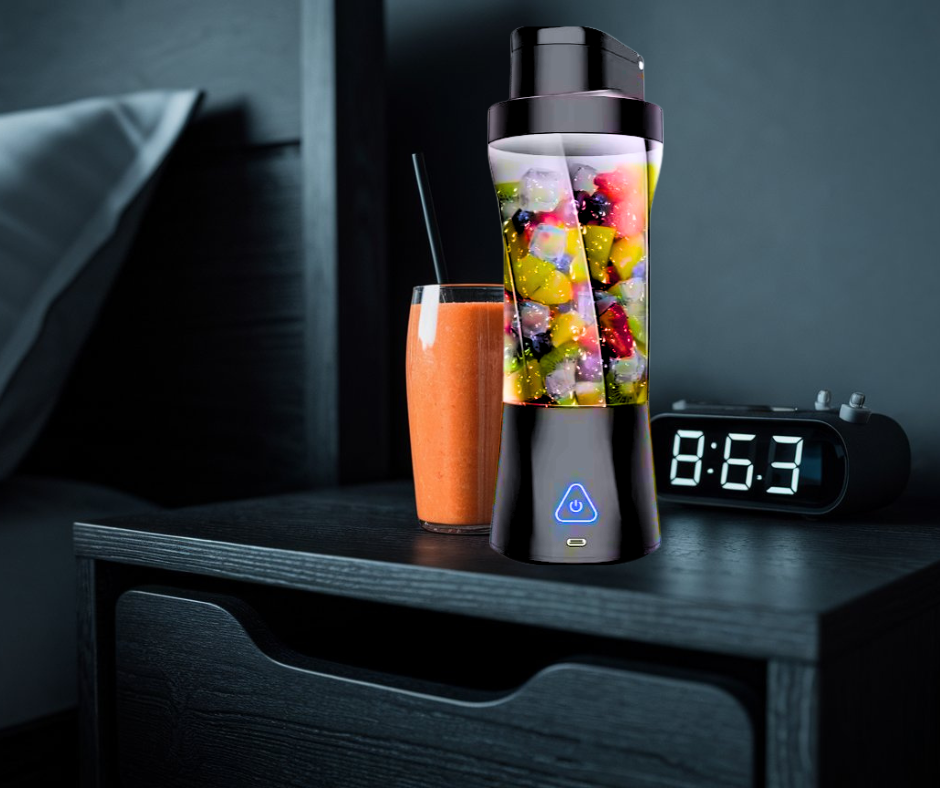 Black portable blender blending smoothie on a nightstand, dark modern design.